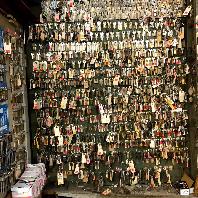 Close view of the key wall: rows of hanging keys, each on a manila tag